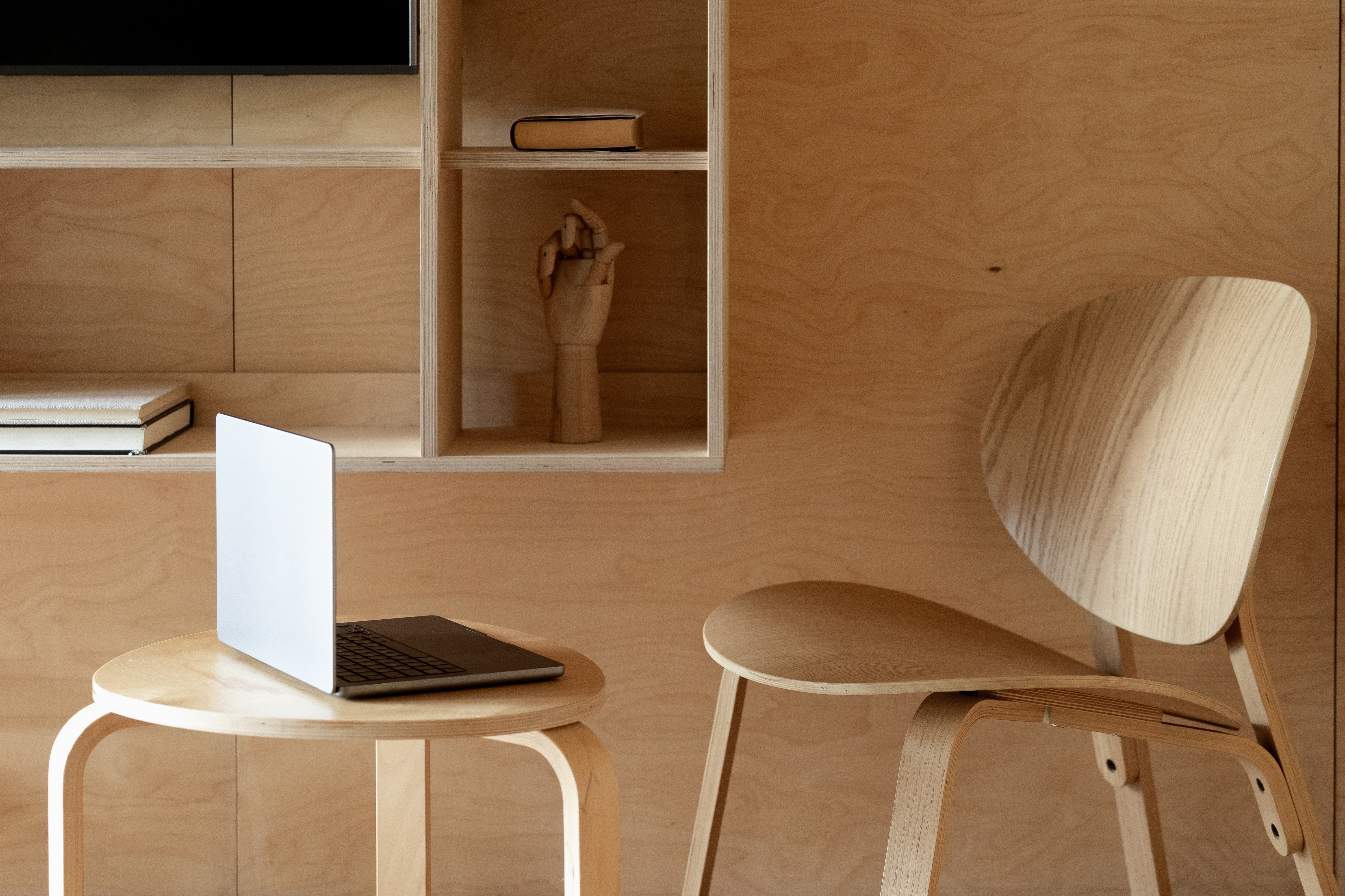 minimalist chair and coffee table with laptop computer.